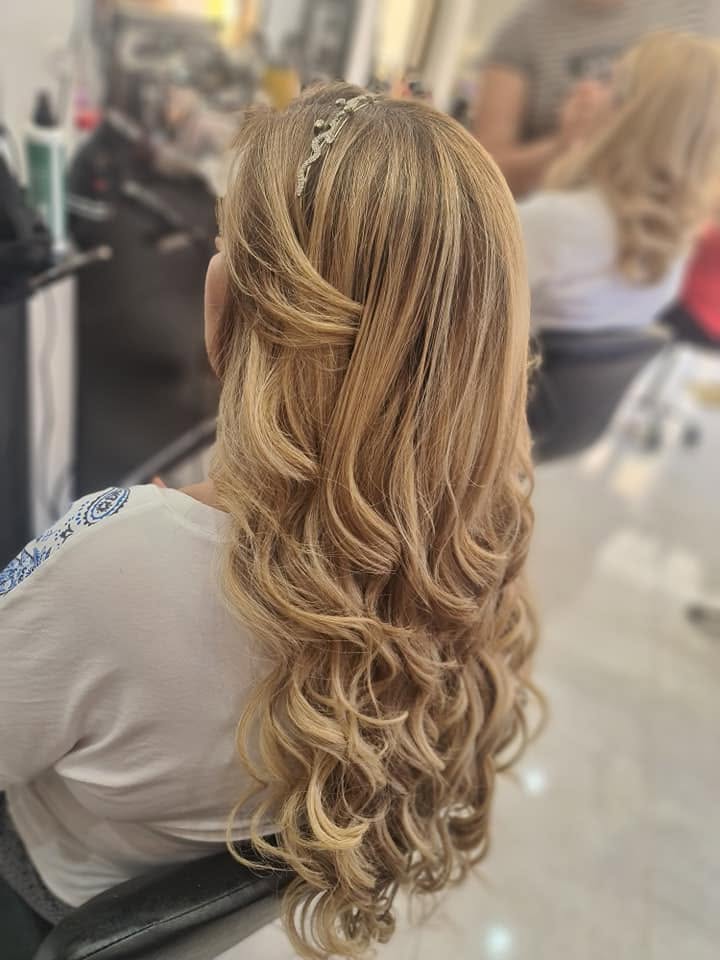 Golden blonde long layered curls with a decorative hair band