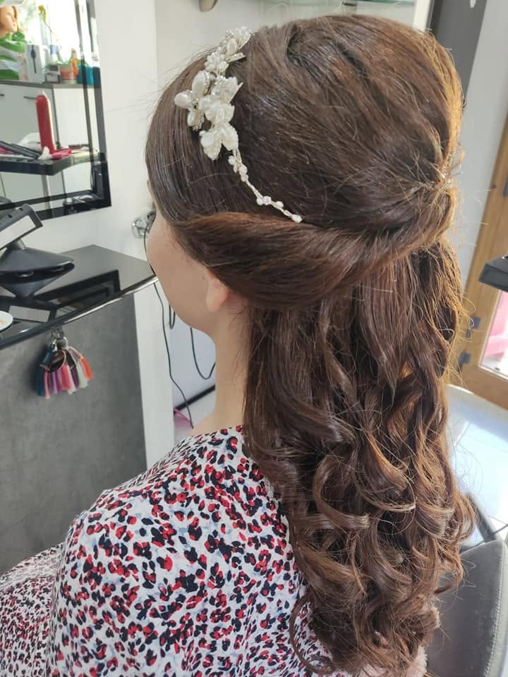 Brunette half-up bridal hairstyle with pearl hair vine and soft curls