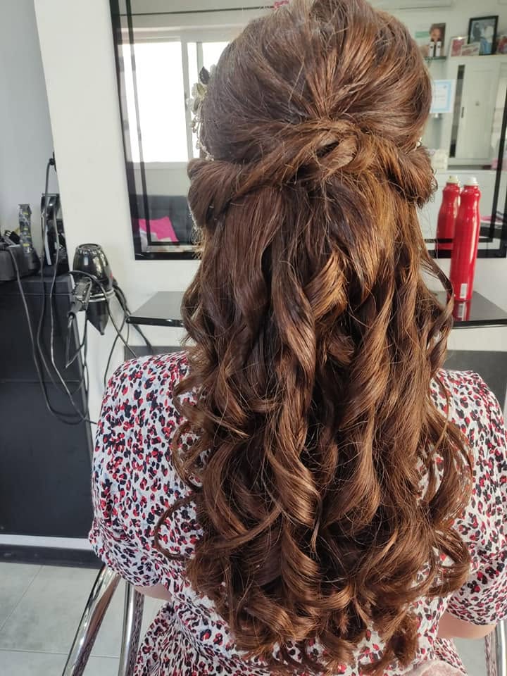 Half-up brunette hairstyle with bouncy spiral curls created in the salon
